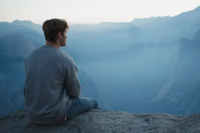 man meditating on mountain - Intelligence in spiritual life